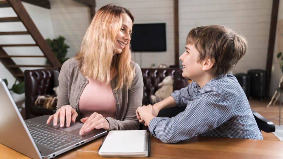 Mother and Son Near the Laptop at Home